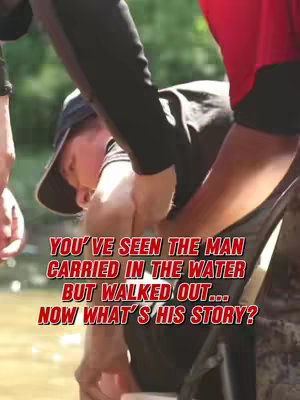 A cover image showing a man being carried into water by two people. The man is wearing a dark hat and the person on the right has a red shirt. The scene takes place outdoors in the water and there is green in the background. The text overlayed in red and orange fonts asks: "YOU'VE SEEN THE MAN CARRIED IN THE WATER BUT WALKED OUT... NOW WHAT'S HIS STORY?"