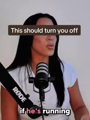 A woman with long black hair is talking into a microphone with a black RODE logo.