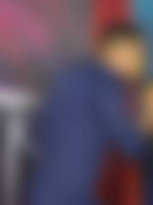 The image is an abstract composition, primarily out of focus with a blurred effect. Predominantly, it features a cool color palette with blues and reds, creating a sense of vague shapes and forms. The layout is such that no specific object or scene can be distinguished due to the blurriness, but there are zones that hint at the presence of a person.