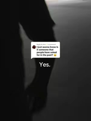 A dimly lit image featuring an arm of a person in silhouette, with a partial view of the person's body. In the upper center, there's a speech bubble with white text on a black background, adding context. The background is a blurred, light-toned area.