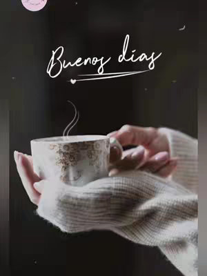 The image shows a person holding a white cup of coffee with a golden design, possibly a floral pattern. The cup emits steam, suggesting it's hot. The hands holding the cup are resting over a grey sweater. Overlayed on the image is white cursive text that says 'Buenos dias'. The background is dark, and a light pink circle is visible near the top left. There are also scattered small white dots, resembling stars.