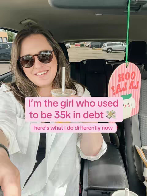 A woman wearing sunglasses smiles while seated in a car. She holds a drink and text overlays provide information about debt. A decorative sign hangs on the car's headrest.