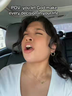 The cover image is a selfie taken inside a car. A young woman with dark hair and hoop earrings is shown from the chest up, with her mouth open in an expression of intense emotion and eyes closed. The car's interior—including the headrest and seat—is visible in the background. Text overlayed at the top says: POV: you let God make every decision in your life.