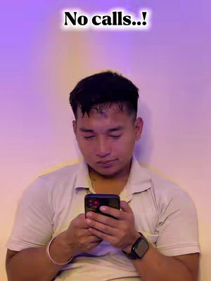 A young man is looking down, holding a smartphone. Text overlay is above his head.
