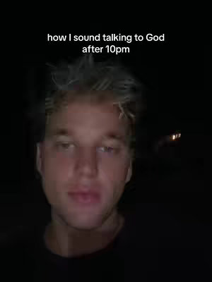A selfie-style shot of a young man against a dark backdrop. The man has light-colored hair and is looking towards the camera with a slight frown. Text overlayed at the top reads, 'how I sound talking to God after 10pm'.
