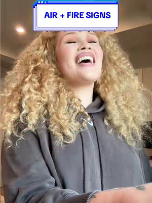 A selfie-style video cover image features a woman with curly blonde hair smiling and looking up. She wears a gray hoodie and a text overlay in a user interface style. The background is a blurry room setting.