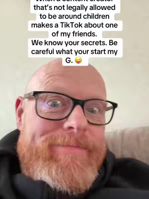 A close-up of a red-bearded man wearing glasses. Text overlays the top portion of the image.