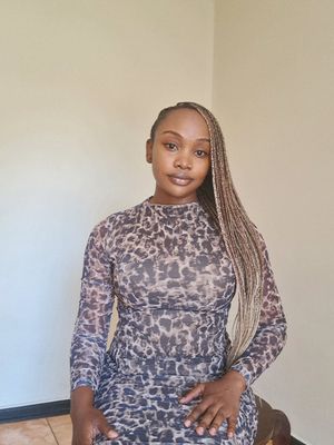 The cover image features a young woman with braided hair, sitting and facing the camera. She wears a long-sleeved, leopard-print dress, and the background is a plain, light-colored wall.