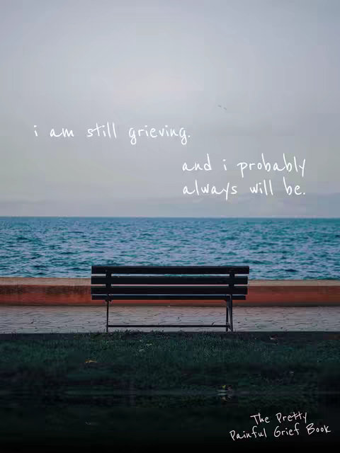 A serene image featuring a black bench on a paved area, set against a backdrop of a calm ocean and a pale sky. The bench has horizontal slats and a simple design. The sky is overcast. Text overlays express a message of grief and acceptance.