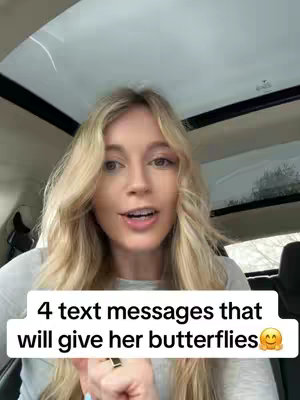 A woman with long blonde hair is speaking directly to the camera. She is positioned in what appears to be a car, with visible interior details. A white bar at the bottom of the image contains text.
