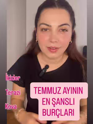 A woman with brown hair and makeup is filmed from the chest up, speaking into a small black microphone attached to her shirt. A pink box with white text overlays her on the right, along with vertical rows of text reading astrological signs on the left side.