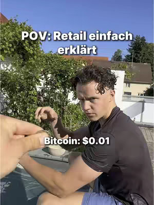 A young man with wet hair and a black t-shirt looks intently at the camera, with text overlays indicating a crypto-related concept. The background shows a clear blue sky and greenery with a blurry background.
