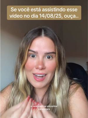 A woman with long blonde hair is centered in the frame, looking directly at the camera with a surprised expression. Above, text in a gold box reads, and below, further text is visible. The background is a simple, lightly colored wall.