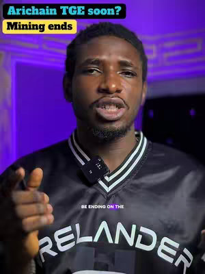 A man with dark skin is centered in a medium shot, set against a blurred purple backdrop. He wears a black and white striped shirt with a logo. The text overlay reads 'Arichain TGE soon? Mining ends' in a yellow outlined box.