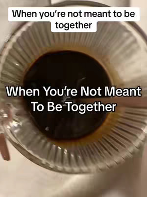 The image shows a close-up view of a clear glass filled with a dark liquid, likely coffee or a similar beverage. The liquid takes up the majority of the frame, with the clear glass rim and a portion of the edge visible, adding a sense of depth. The overall color scheme is dark, with the deep brown of the liquid contrasting against the lighter backdrop, and the text overlayed on top of the frame.