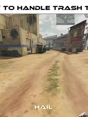 A first-person view in a Call of Duty game, set in a desert environment with buildings and open pathways. The foreground is the sandy ground with wheel track marks, and the background shows buildings with worn textures and a sky overhead.