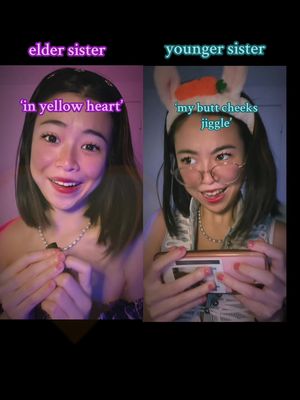A split image shows two women, presumably sisters. The left side features a woman with fair skin, dark hair, and a necklace, titled 'elder sister' with the text overlay 'in yellow heart'. The right side shows another woman in glasses and a bunny ear headband, holding a handheld device, described as 'younger sister' with the text overlay 'my butt cheeks jiggle'. The background is dark, emphasizing the subjects.