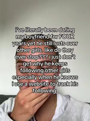 The image showcases a person covering their mouth in a selfie-style video. The background is plain, drawing focus to the person and the overlaid text. The text describes a relationship issue about a boyfriend constantly lusting over other girls.