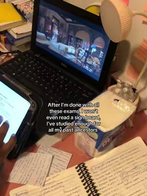 The cover image shows a cluttered desk with a laptop displaying a video scene, a tablet, and handwritten notes. A hand is visible near the tablet. A desk lamp is lit.