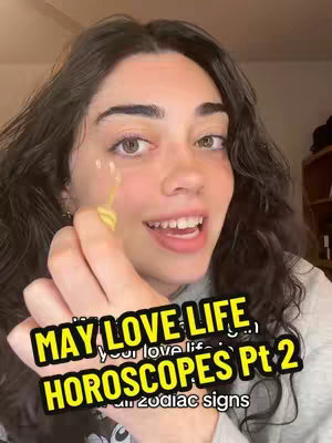 A close-up of a young woman with dark curly hair, smiling and holding up her hand, on which a yellow-and-white cosmetic design appears. She is wearing a light gray sweater. Overlayed on the image are large, colorful text boxes, using a mix of yellow and green fonts.