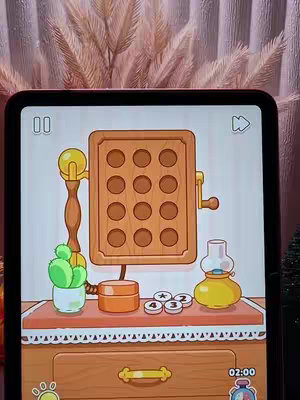 The cover image is a screenshot from an iPad game, featuring a cartoonish scene set on a wooden surface. The main focus is on a vintage wooden telephone with multiple holes. Alongside the phone, there is a small green cactus in a pot, a small orange box, three round tokens and a yellow lamp. The setting appears to be a room with a light-colored wall and a window with a floral design and a brown cabinet in the background.