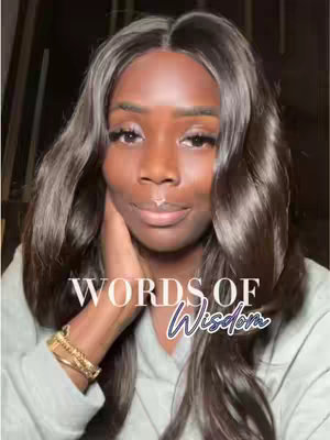 The cover image features a woman with dark skin and long, wavy, dark hair. She's wearing a light gray hoodie and a gold bracelet. She's holding her hand near her face with a gentle, thoughtful expression. Overlayed on the image are the words "WORDS OF Wisdom" in a white and teal font with script and sans-serif style