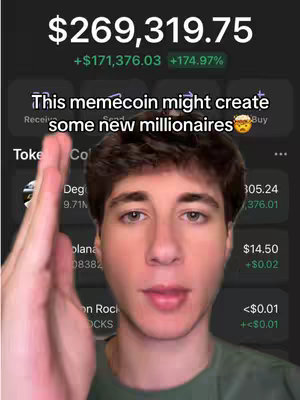A young man with short brown hair is centered in the frame, looking directly at the camera. Behind him, a cryptocurrency trading interface is displayed, with financial statistics and market data visible, as well as the text annotation 'This memecoin might create some new millionaires'. He has his right hand raised. The background appears dark, suggesting a mobile app interface for cryptocurrency trading.