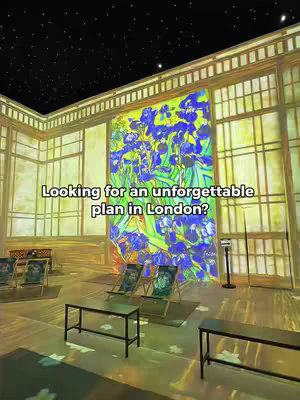 An immersive interior scene from a Van Gogh exhibit, with a large painting of Irises dominating the background, lit by projected lighting, and chairs set up for viewers.
