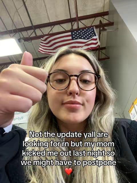 A young woman with blonde hair and round glasses giving a thumbs-up in front of an American flag. Text overlays reads about her mom kicking her out, and possibly having to postpone something.