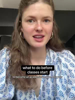 A young woman with long brown hair and hoop earrings is centered in the frame. She is smiling and talking. She is wearing a blue and white pattern top. Overlaid on the image is text inside a black box.