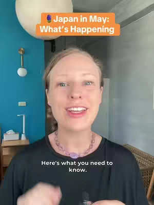 A woman with blonde hair is centered in the frame, smiling at the camera. Above her, a rectangular orange banner reads, Japan in May: What's Happening. Below her is text reading, Here's what you need to know.