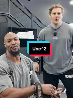 The cover image features two muscular men in a gym setting. The man on the left is seated, with a microphone attached to his shirt, and holding a phone. The man on the right is standing, also with a microphone. A text overlay reads "Unc^2". The background includes gym equipment and stairs.