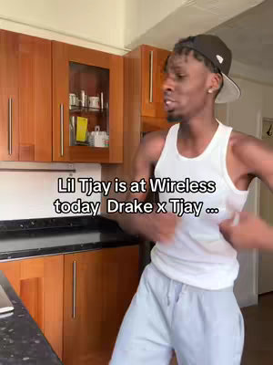 A man in a white tank top and gray sweatpants speaks in front of a kitchen. Text overlay states "Lil Tjay is at Wireless today Drake x Tjay ..."