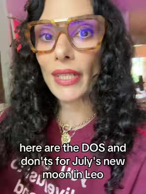 A woman with long, curly dark hair, wearing large, square, amber-colored glasses and a dark red top, looks directly at the camera and speaks. Overlayed text reads "here are the DOS and don'ts for July's new moon in Leo".