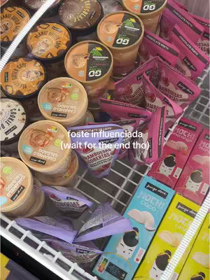 The image shows a freezer filled with various food products, particularly ice cream and packaged snacks. The products are arranged neatly, with branding clearly visible. A text overlay in the image states "foste influenciada (wait for the end tho)", suggesting a review or recommendation context. The overall composition is bright and colorful, emphasizing the products on display.