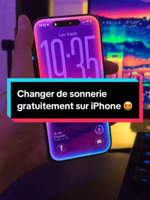 The image shows an iPhone held by a hand, showcasing the phone's screen with a purple and blue gradient lock screen and an overlay with text in french. The background has a monitor displaying another image with a neon-like color scheme.
