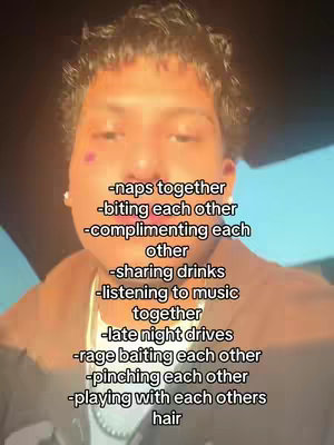 A close-up selfie of a young person with brown skin and curly hair. The person is centered in the frame, with some of their neck and part of their shoulders visible. They have two small crystal stud earrings on their ears and a small dark mark or mole on their left cheek. The cover hosts a text overlay listing relationship-based activities.