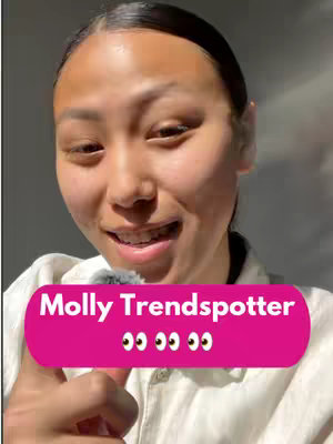A woman with dark hair and a light complexion smiles at the camera. She is wearing a white shirt. Behind her is a neutral grey/white background, and an eye-catching pink oval graphic with white text labeled 'Molly Trendspotter'.