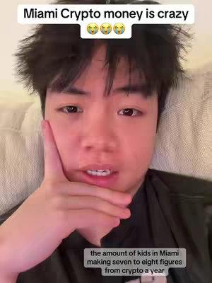 The cover image shows a close-up shot of a young, light-skinned Asian male. He is looking directly at the camera, with a pensive expression, his hand is on his cheek. Overlayed text at the top says Miami Crypto money is crazy with emoji. At the bottom of the image, it says, the amount of kids in Miami making seven to eight figures from crypto a year.