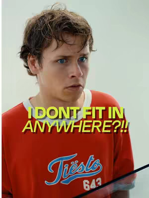 The cover image features a young man looking up with a concerned expression. He has short, brown hair and blue eyes. He is wearing a red t-shirt with a white collar and sleeves, featuring the logo of "Tiësto 643". The text overlay in yellow reads, "I DON'T FIT IN ANYWHERE?!"