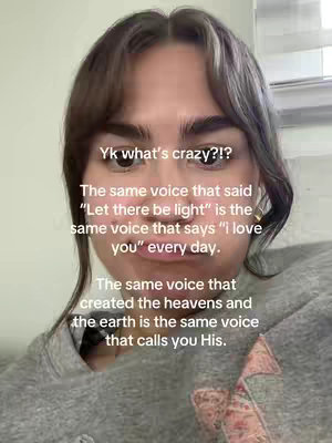 A selfie-style video cover image with a woman in a gray hoodie. Text overlays her face, with additional text below describing the message. The background is a plain wall with a window or blinds visible.