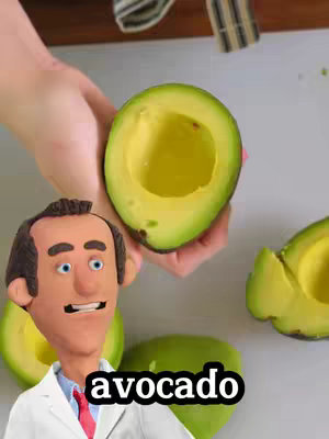 The image features a large, cut avocado held between two hands against a neutral background. An animated cartoon doctor appears to the left of the avocado, his expression is lively. The word "avocado" appears in a rounded black box overlayed near the bottom. Other avocado halves are visible.