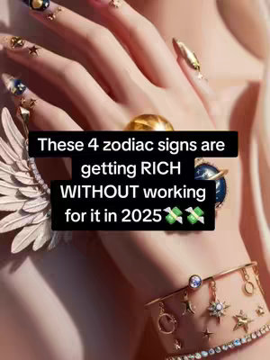 A close-up shot showcases a hand adorned with elaborate jewelry and sculpted nails. The hand is captured from a slightly angled perspective, with the focus on the long, sharply-tapered nails that feature an array of gems and gold accents. A prominent gold ring sits on one finger. The background appears blurred, suggesting a soft, elegant aesthetic. Overlayed text blocks in black, reads "These 4 zodiac signs are getting RICH WITHOUT working for it in 2025", accompanied by cash emojis.