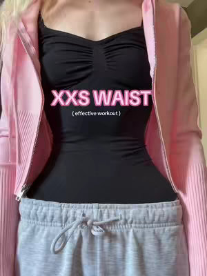 The image shows a person from the chest up, wearing a black top and gray sweatpants. The person also wears a pink jacket. Text "XXS WAIST (effective workout)" is overlayed on the image.
