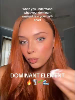 A selfie-style video cover featuring a woman with long, red hair. The text overlay states, 'when you understand what your dominant element is in your birth chart,' and, 'DOMINANT ELEMENT' with associated symbols: fire, a tornado, a plant, and a wave. The background is a room setting with a window providing natural light.