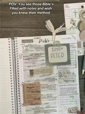 An overhead shot of an open spiral notebook Bible with notes, highlighters, and sticky notes. The Bible is open to the book of 1 Peter, with handwritten notes and highlighted passages. Various decorative elements, a pen, and a paper with stickers are placed around the Bible.