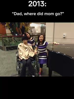 A photo from 2013 with the text overlayed. The image shows three young girls standing near a piano and a person in a wheelchair. The foreground has the writing, and the background has interior decor.