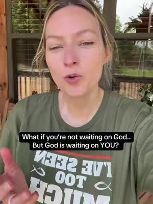 A woman with blonde hair and a green t-shirt is looking towards the camera and speaking. On her t-shirt is a reversed logo with the text'I've seen too much and a fish symbol. A black text overlay is towards the bottom of the image and shows the text: 'What if you're not waiting on God.. But God is waiting on YOU?' The background appears to be a wooden porch with a window and some plants.