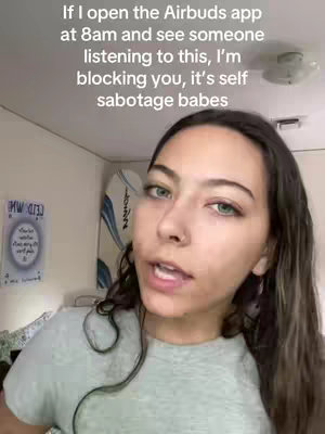 A young woman with brown hair and green eyes is centered in the frame, speaking directly to the viewer. Text overlays appear at the top, with the background being a lightly decorated room, featuring a partially visible surfboard and a poster.