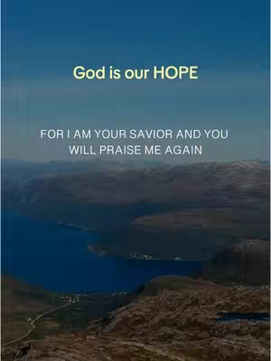 The image shows a scenic landscape with a body of water and mountains under a blue sky. Overlayed on top is a text that reads: 'God is our HOPE' and another text underneath that says: 'FOR I AM YOUR SAVIOR AND YOU WILL PRAISE ME AGAIN.' The text is in contrasting white and yellow fonts.